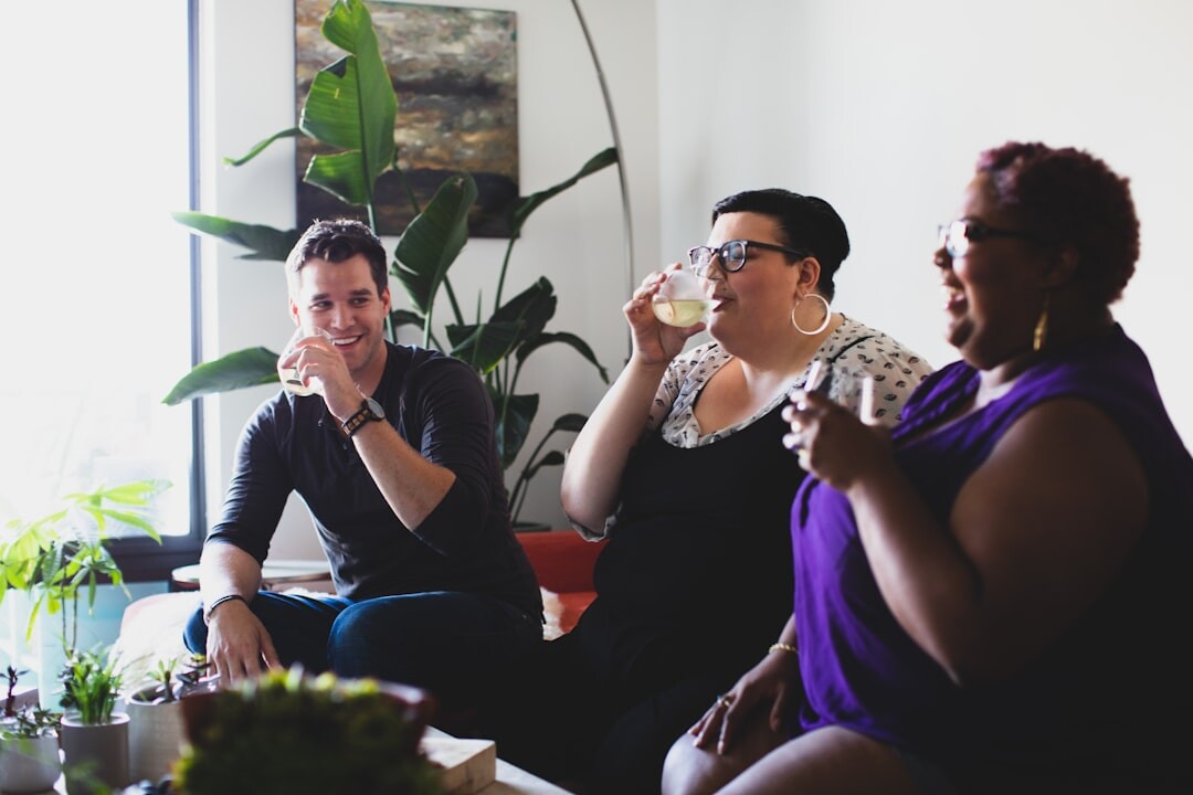 group of friends laughing on couch